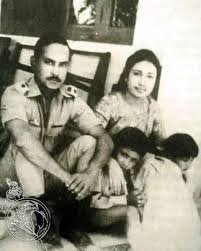 Black and white family portrait: Ziaur Rahman in military uniform with Khaleda Zia and two young children.